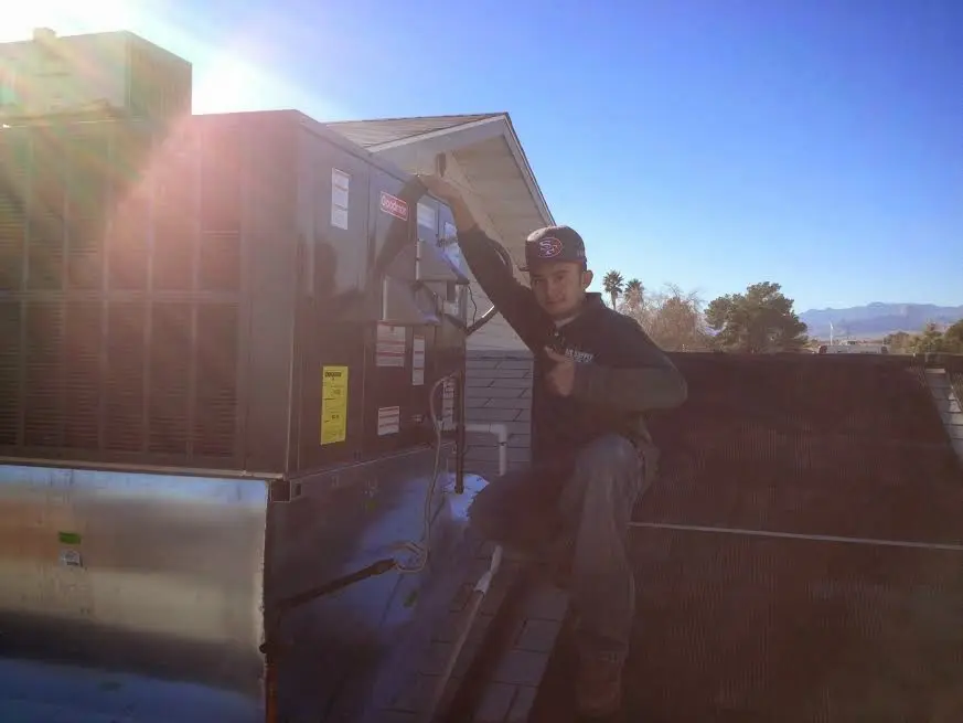 HVAC technician performing HVAC Inspection on a rooftop unit in Wheelersburg